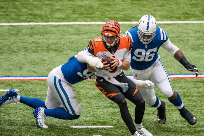 Indianapolis Colts defensive tackle DeForest Buckner (left) and defensive end Denico Autry (96) converge on Cincinnati Bengals quarterback Joe Burrow for a sack.